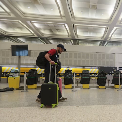 A traveler walks past covered Spirit Airlines kiosks, Saturday, May 2, 2026, at George Bush Intercontinental Airport, in Houston. (AP Photo/Lekan Oyekanmi)