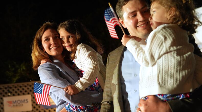 From left, Rebecca Bennett, Democratic candidate for New Jersey's 7th Congressional District, holds her daughter Rosie, alongside her husband Alex Hydrean and daughter Millie during a primary election night watch party after winning the Democratic nomination Tuesday, June 2, 2026, in Bridgewater, N.J. (AP Photo/Ryan Murphy)