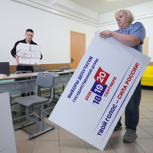 Precinct election commission members set up a polling station for the upcoming parliamentary elections in Moscow, on Thursday, Sept. 17, 2026. (AP Photo/Pavel Bednyakov)