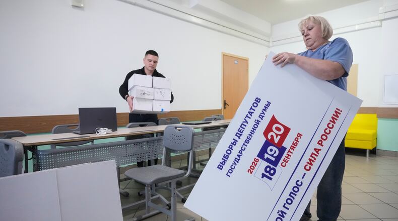 Precinct election commission members set up a polling station for the upcoming parliamentary elections in Moscow, on Thursday, Sept. 17, 2026. (AP Photo/Pavel Bednyakov)