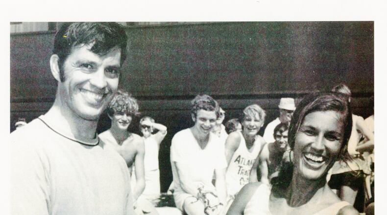 Tim Singleton hands over the hardware and congratulates Gayle Barron, the first women’s winner of the AJC Peachtree Road Race in 1970.