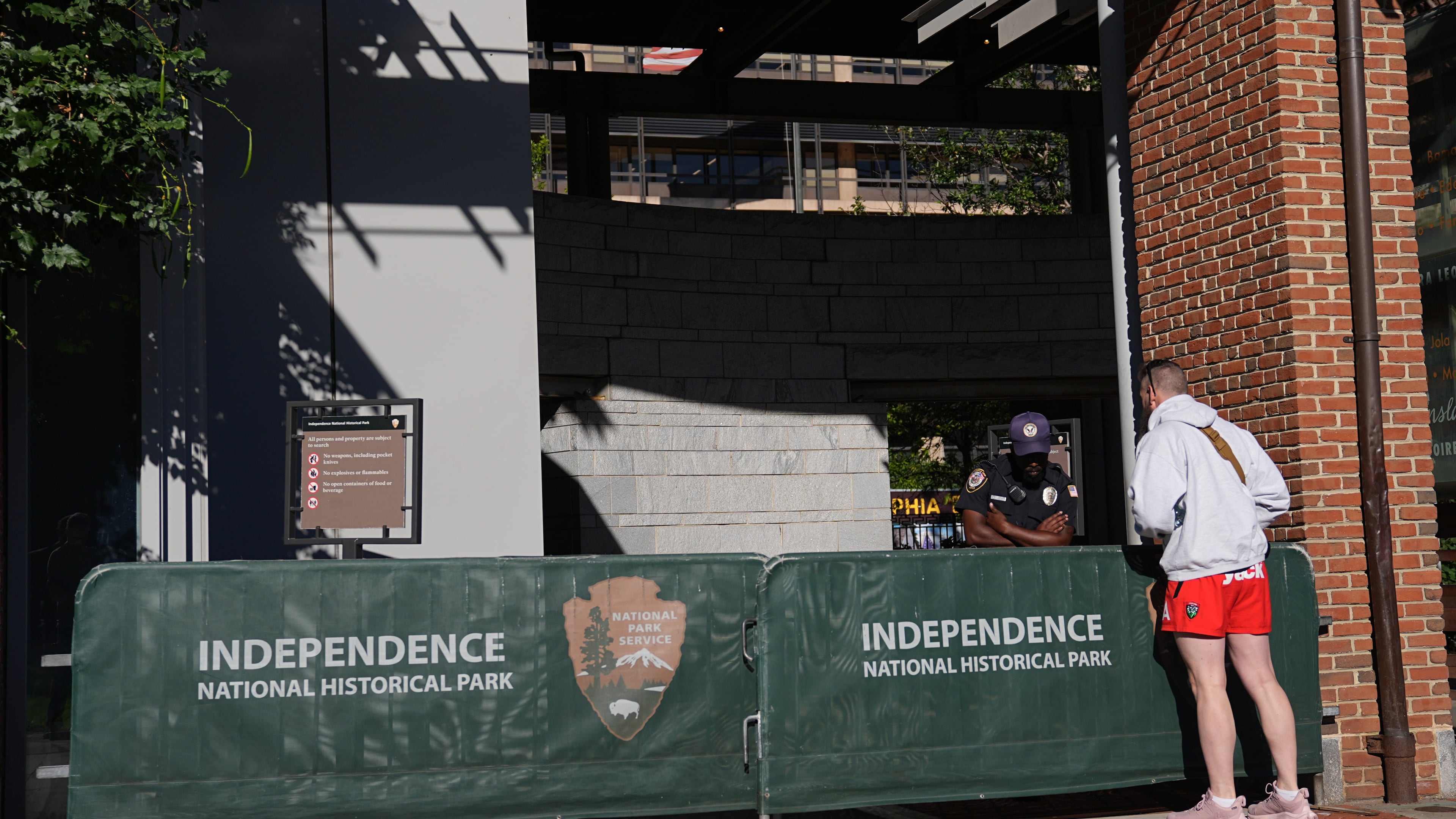 A man looks on in front of a barrier as Liberty Bell Center is closed due to a government shutdown, in Philadelphia, Wednesday, Oct. 1, 2025. (AP Photo/Matt Rourke)