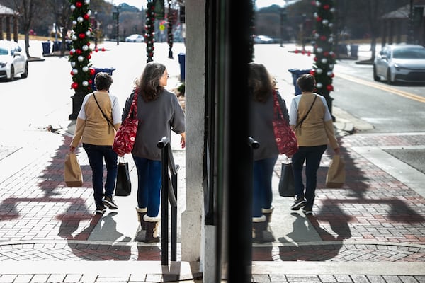 Women walk by with shopping bags in Dallas, Ga., on Saturday, November 22, 2025. Marjorie Taylor Greene announced she is resigning from Congress, Dallas is a town in her district. (Abbey Cutrer / AJC)