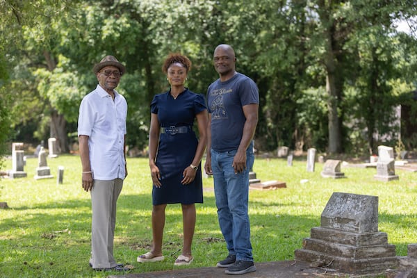 (L-R) Paul Ponder, Tamara Dorsey and Thomas Dorsey pose for a portrait near family gravestones at the Fayetteville Cemetery in Fayetteville on Tuesday, June 24, 2025. (Arvin Temkar/AJC)