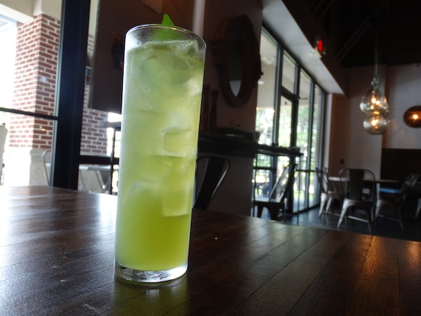 Beers & Spirits Director Jerad Henry's Pollen Count drink featuring cathead honeysuckle vodca, prosecca, pierre ferrand dry orange curacao, cucumber, basil and sparkling water on the rocks. CREDIT: Rodney Ho/rho@ajc.com