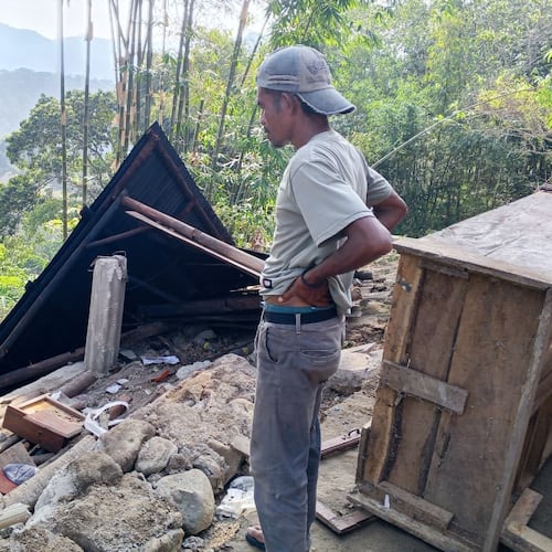 A man examines the damage to a building following an earthquake in East Manggarai, East Nusa Tenggara province, Indonesia, Saturday, Aug. 15, 2026. (AP Photo/Kurniawan)