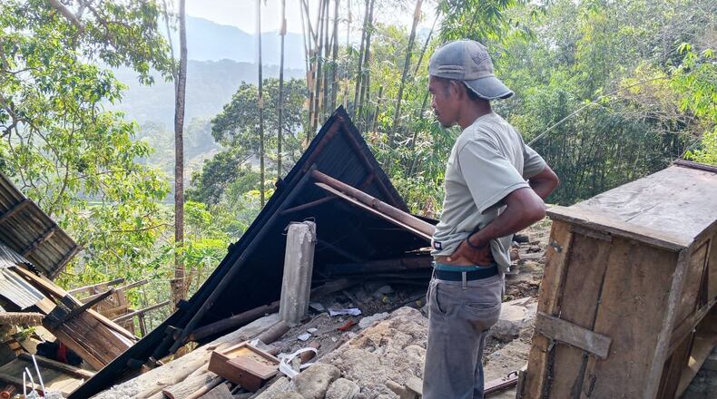 A man examines the damage to a building following an earthquake in East Manggarai, East Nusa Tenggara province, Indonesia, Saturday, Aug. 15, 2026. (AP Photo/Kurniawan)