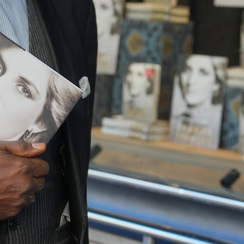 A man holds a copy of the new book by Earl Spencer, brother of the late Princess Diana, entitled "Swan Song: Diana, My Sister," outside a bookshop in central London, Tuesday, Sept. 22, 2026. (AP Photo/Kin Cheung)