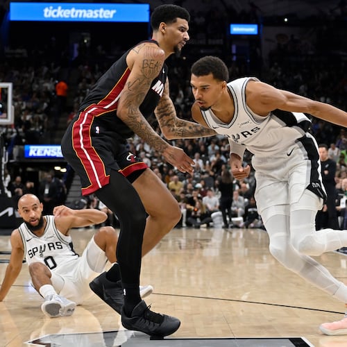 San Antonio Spurs center Victor Wembanyama, right, drives against Miami Heat center Kel'el Ware, front left, during the second half of an NBA basketball game, Thursday, Oct. 30, 2025, in San Antonio. (AP Photo/Darren Abate)