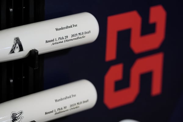 Specialized baseball bats are seen on display before the first round of the MLB baseball draft Sunday, July, 13, 2025 in Atlanta. (AP Photo/Mike Stewart)