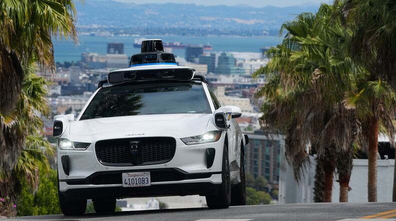 FILE - A Waymo car drives up a hill in San Francisco, Sept. 4, 2025. (AP Photo/Jeff Chiu, File)