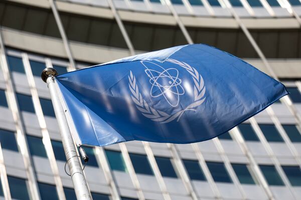 FILE - In this June 7, 2021, file photo, the flag of the International Atomic Energy Agency (IAEA) waves at the entrance of the Vienna International Center in Vienna. (AP Photo/Lisa Leutner, File)
