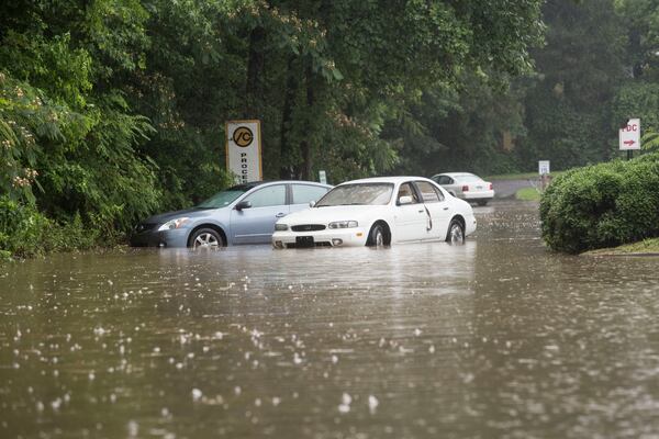 A parking lot on Mimms Drive in Gwinnett County was flooded by heavy rain Tuesday. CHAD RHYM / CHAD.RHYM@AJC.COM