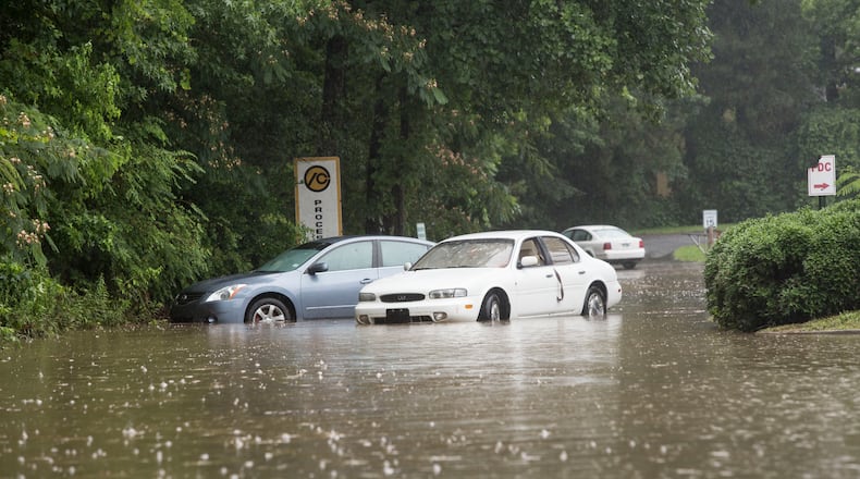 A parking lot on Mimms Drive in Gwinnett County was flooded by heavy rain Tuesday afternoon. CHAD RHYM / CHAD.RHYM@AJC.COM