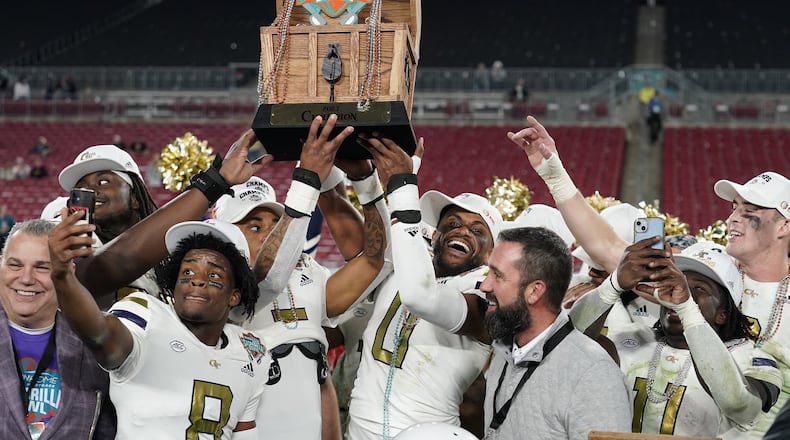 Gasparilla Bowl champions: Georgia Tech players hold the trophy after defeating Central Florida 30-17 in the Gasparilla Bowl Friday in Tampa.