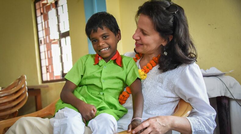 Caroline Boudreaux, pictured here with an orphan, founded the Miracle Foundation to help ensure children like him reach their full potential. The nonprofit recently launched its annual Mother s Day campaign to provide for motherless children in places like India, Uganda, Sierra Leone, Kenya and Ethiopia. CONTRIBUTED