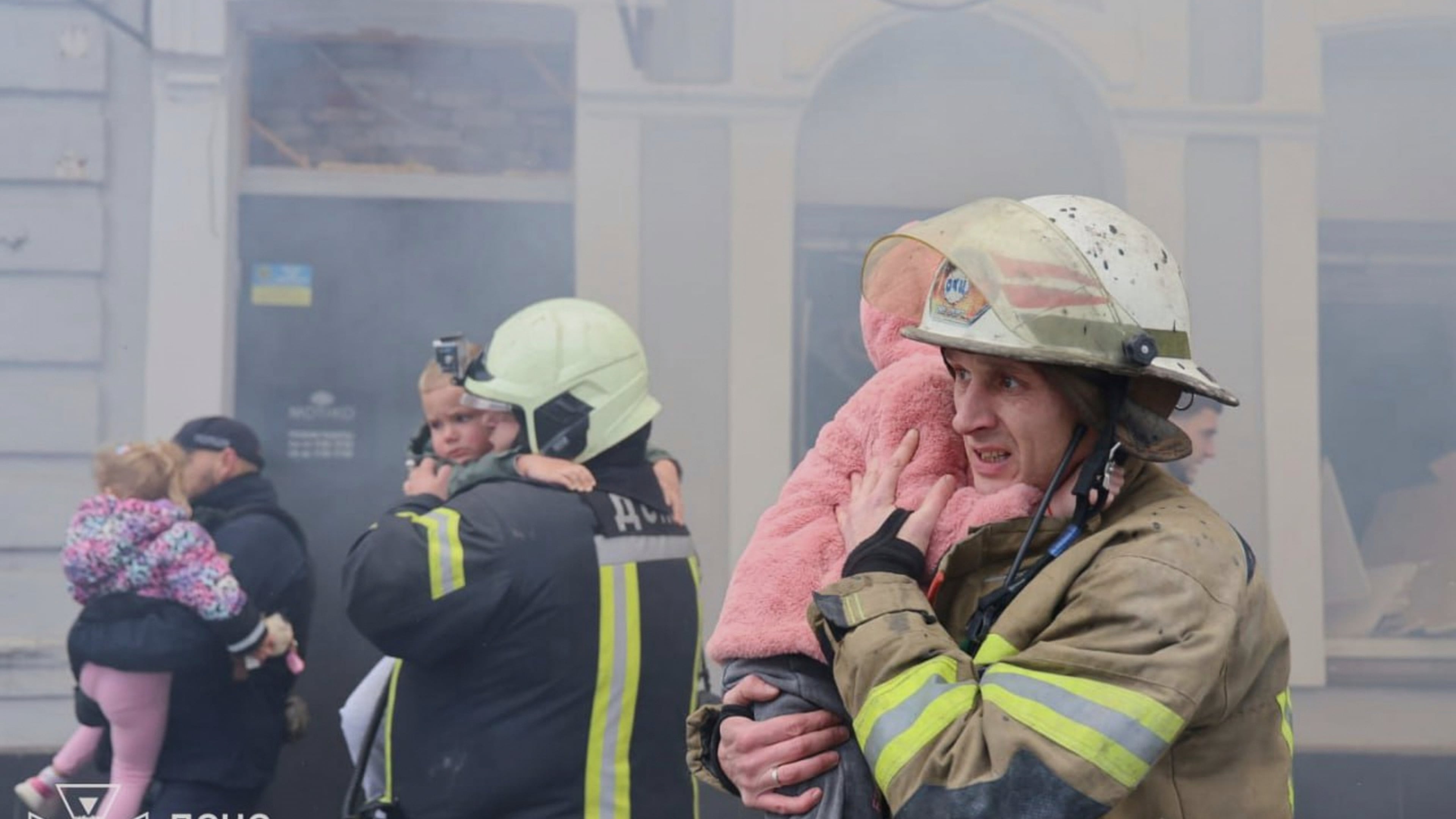 In this photo provided by the Ukrainian Emergency Service, rescuers evacuate children after Russian drones hit a city kindergarten during an attack in Kharkiv, Ukraine, Wednesday, Oct. 22, 2025. (Ukrainian Emergency Service via AP)