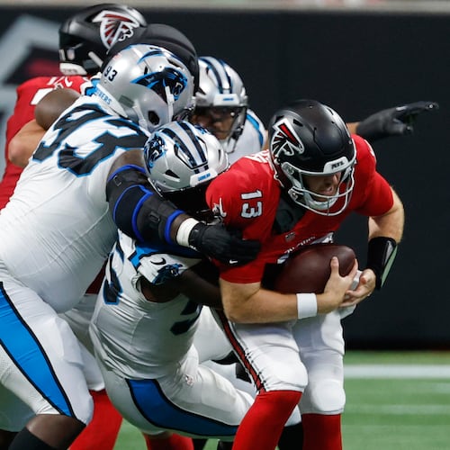 Atlanta Falcons quarterback Cooper Rush (13) is sacked during an NFL football game in Atlanta, Sunday, Sept. 20, 2026. (AP Photo/Erik S. Lesser)