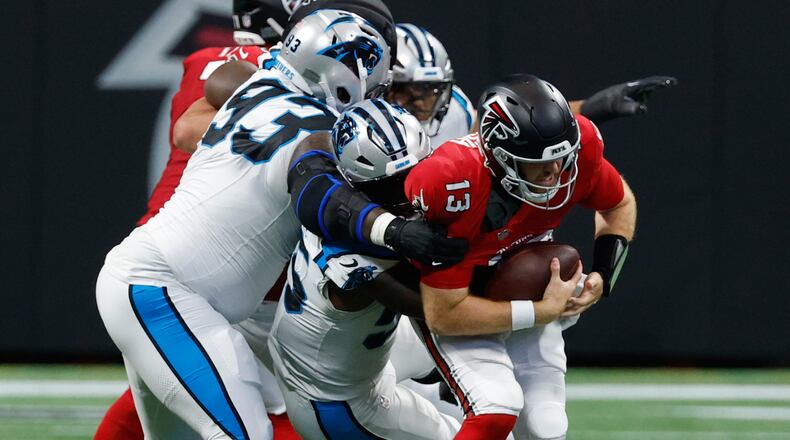 Atlanta Falcons quarterback Cooper Rush (13) is sacked during an NFL football game in Atlanta, Sunday, Sept. 20, 2026. (AP Photo/Erik S. Lesser)