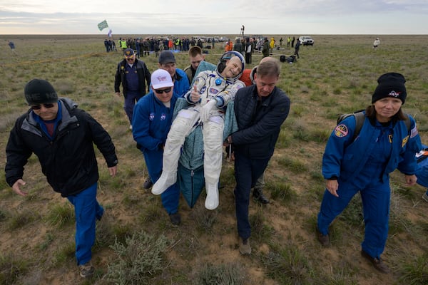 NASA astronaut Don Pettit gestures as he is carried to a medical tent shortly after landing in a Soyuz MS-26 spacecraft with Roscosmos cosmonauts Alexey Ovchinin and Ivan Vagner near the town of Zhezkazgan, Kazakhstan, Sunday, April 20, 2025, (Bill Ingalls/NASA via AP)