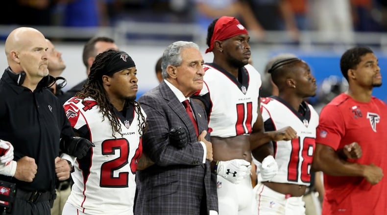 Atlanta Falcons owner Arthur Blank joins arms with his players during the playing of the national anthem before the game against the Detroit Lions at Ford Field on September 24, 2017 in Detroit. (Photo by Leon Halip/Getty Images)