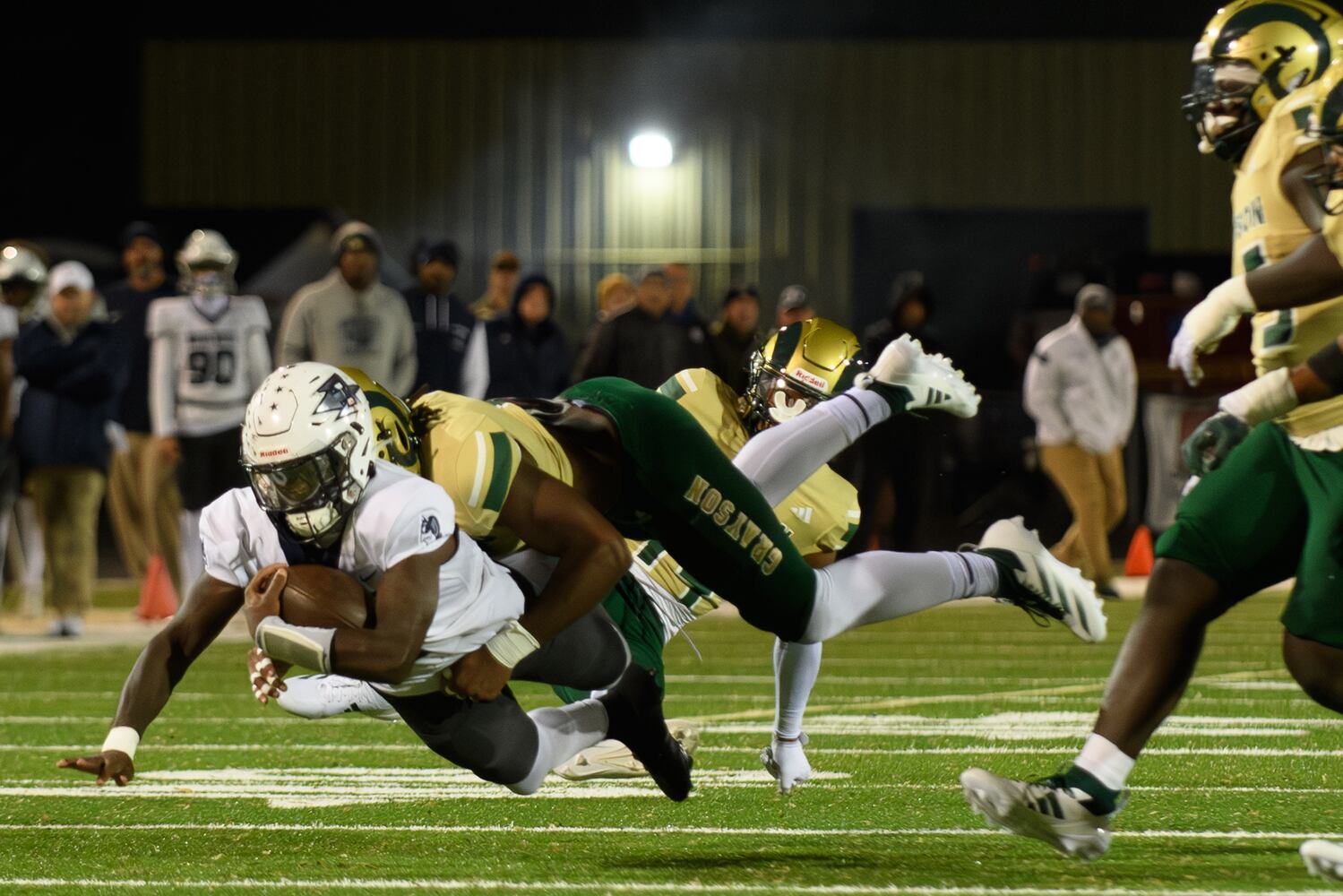 Grayson senior defensive lineman Andre Fuller, #9, tackles Norcross’ quarterback Dillon Mohammed. (Jamie Spaar for the Atlanta Journal Constitution)