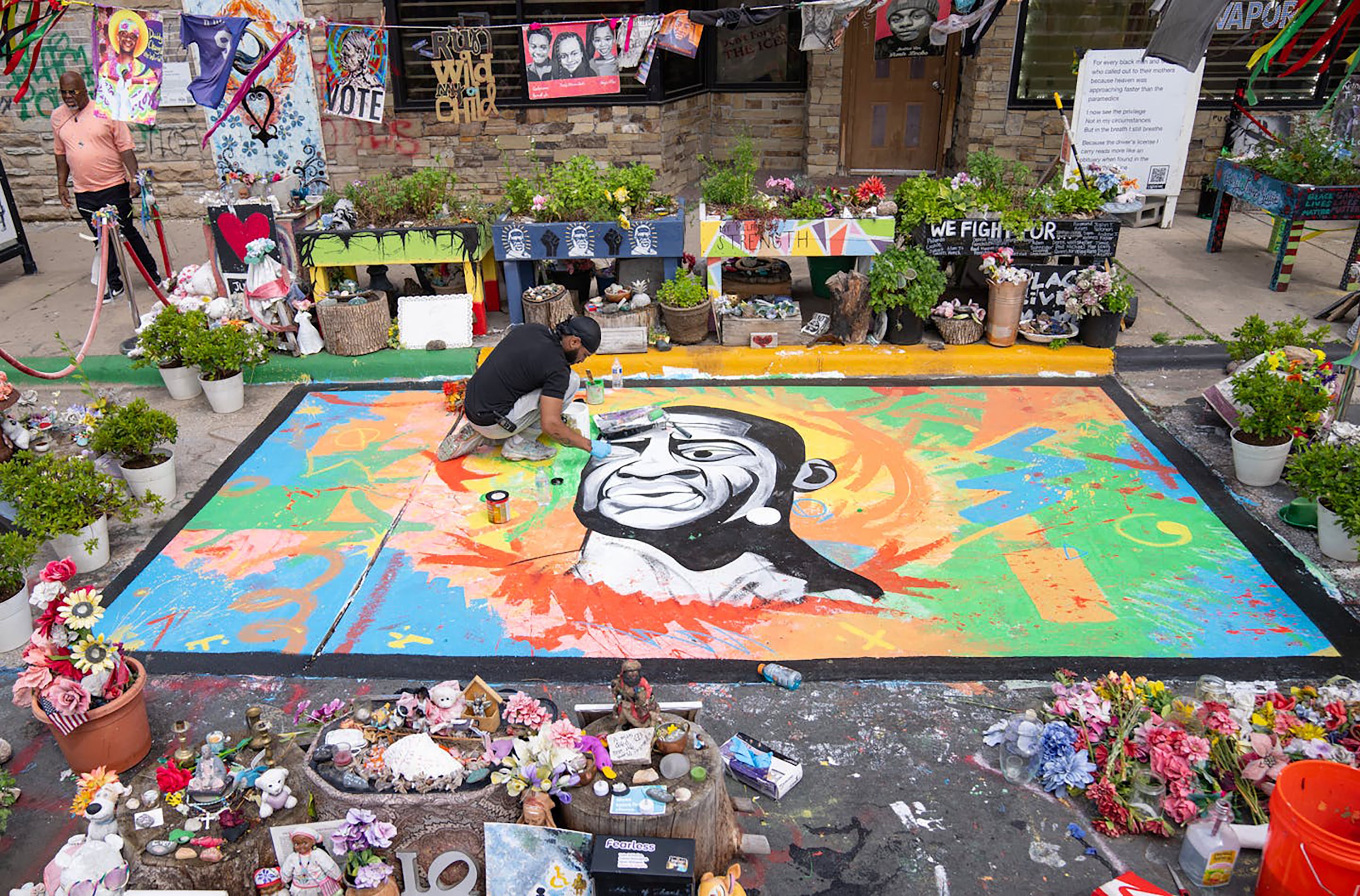 Antonio Jenkins paints a mural of George Floyd on the spot where he was murdered in 2020 at George Floyd Square in Minneapolis on May 25, 2024. (Alex Kormann/The Minnesota Star Tribune/TNS)
