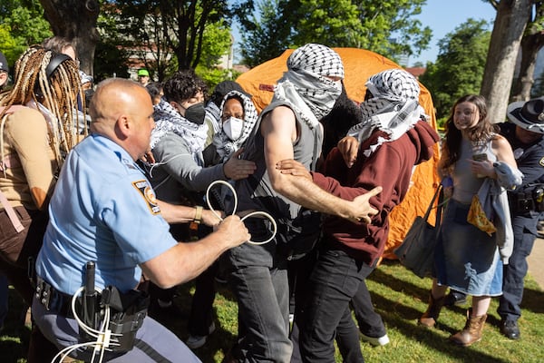 Police arrest pro-Palestinian protesters who set up an encampment at the Emory campus in 2024. (Arvin Temkar/AJC)
