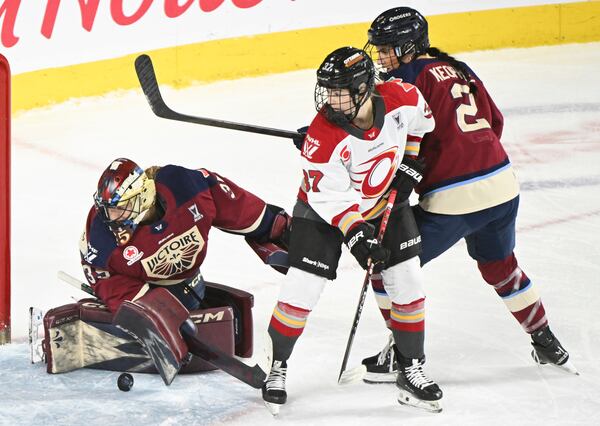 Ottawa Charge's Rebecca Leslie (37) moves in against Montreal Victoire goaltender Ann-Renee Desbiens (35) as Victoire's Mariah Keopple (2) defends during second-period PWHL hockey playoff action in Laval, Quebec, Sunday, May 11, 2025. (Graham Hughes/The Canadian Press via AP)