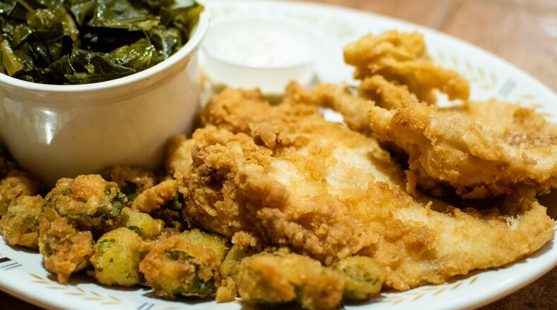 The fried catfish plate at Vittles comes with a salad and two sides, shown here with collard greens and fried okra.