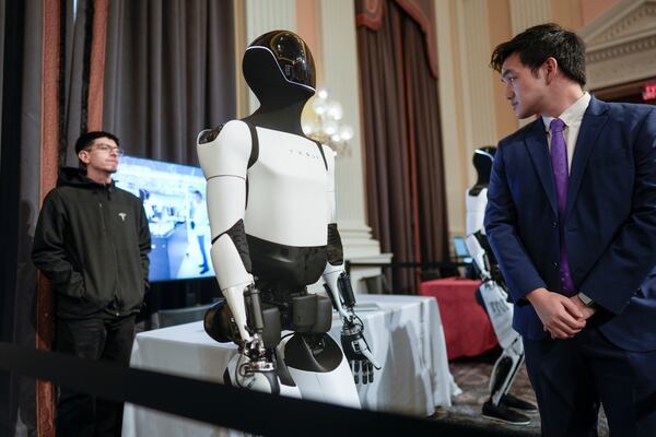 A Tesla robot is displayed as U.S. robotics companies look for congressional support to compete with Chinese companies, on Capitol Hill in Washington, Wednesday, March 26, 2025. (AP Photo/J. Scott Applewhite)