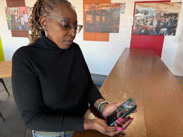 Benita Harris shares a photo of the shot-up window at the Centers for Disease Control and Prevention. A bullet hole in the window, by the desk where she used to sit, was head height. Harris was forced out of the CDC in the turmoil of spring 2025. She said she believes the work she did helping lower barriers to health care will prevail in the end. (Ariel Hart/AJC)