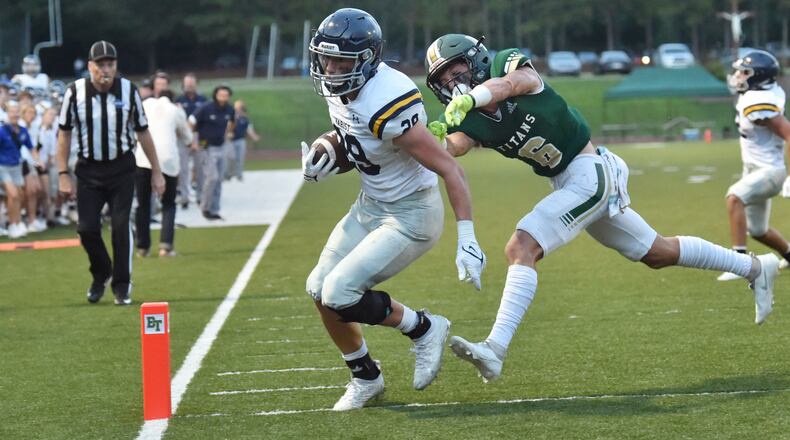 Marist running back Quinn Gooding (29) scores a touchdown past Blessed Trinity's Ashton Abrew (6) in the first half at Blessed Trinity Catholic High School in Roswell on Friday, August 27, 2021. (Hyosub Shin / Hyosub.Shin@ajc.com)