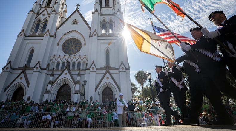 An honor guard leads a group of dignitaries past the Cathedral of St. John the Baptist during the beginning of the 200th anniversary of Savannah's St. Patrick's Day parade, Saturday, March 16, 2024, in Savannah, Ga. The parade lineup featured at least 230 pipe-and-drum bands, dignitaries, marching military units and shamrock-decorated floats. (AJC Photo/Stephen B. Morton)