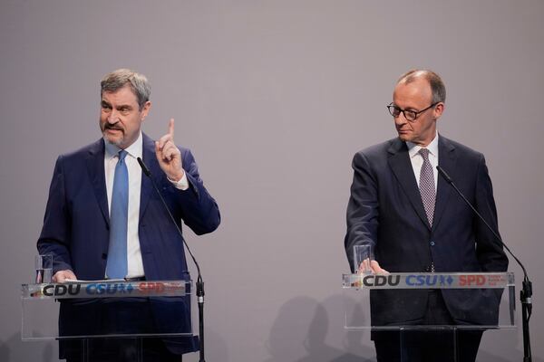 Markus Soeder, chairman of Bavarian's Christian Social Union party and Friedrich Merz, Christian Democratic Union party chairman, address the media after reaching an agreement between their parties on a coalition for a new German government at a news conference in Berlin, Germany, Wednesday, April 9, 2025. (AP Photo/Ebrahim Noroozi)