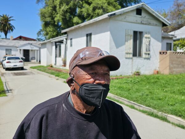 Eaton fire survivor James Mosley, 85, who stayed put on his home during the Eaton Fire wears a face mask in Altadena, Calif., on Friday, April 4, 2025. (AP Photo/Damian Dovarganes)