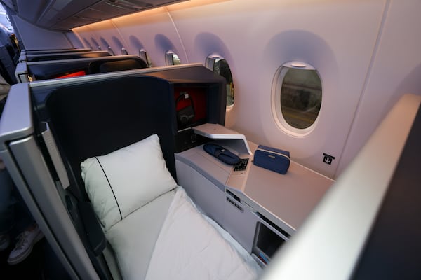 The Delta One seating area iincludes a lie-flat bed. (Jason Getz/AJC)
