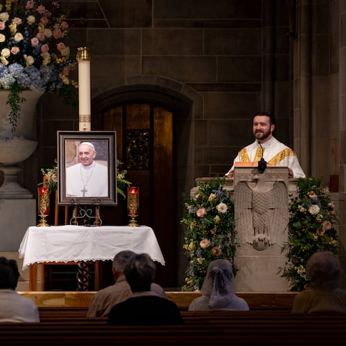A portrait of the late Pope Francis sits atop a table during morning Mass at Cathedral of Christ the King Catholic Church in Atlanta, Georgia on Monday, April 21, 2025. (Ben Hendren for The Atlanta Journal-Constitution)