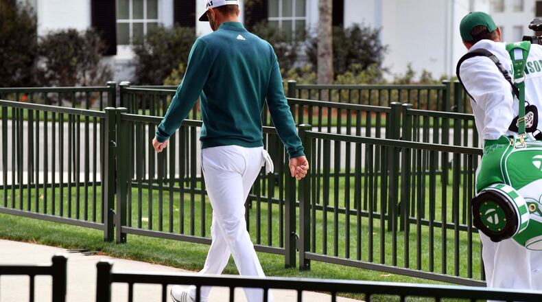 Dustin Johnson walks off the first tee after deciding not to play in the opening round of the 81st Masters tournament at the Augusta National Golf Club on Thursday. (Brant Sanderlin/Special)