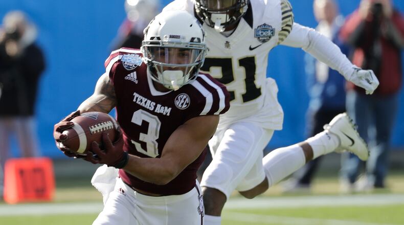 Texas A&M's Christian Kirk (3) catches a pass as Wake Forest's Essang Bassey (21) defends during the first half of the Belk Bowl NCAA college football game in Charlotte, N.C., Friday, Dec. 29, 2017. (AP Photo/Chuck Burton)