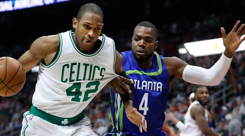 -Boston Celtics center Al Horford (42) drives against Atlanta Hawks forward Paul Millsap (4) in the first half of an NBA basketball game Friday, Jan. 13, 2017, in Atlanta. (AP Photo/John Bazemore)