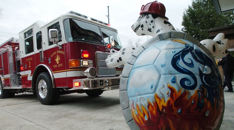 061229 - SANDY SPRINGS, GA - (north Fulton) -- Friday, December 29, 2006  was the launch day for the new Sandy Springs Fire Department with much hoopla at Fire Station 2 on Johnson Ferry Road one of the town's famous turtles is there to greet a Sandy Springs fire engine as it enters its new home.   The City of Sandy Springs took over four fire stations today and were officially responsible for fire calls in their new, young city.  (ANDY SHARP/ AJC staff)