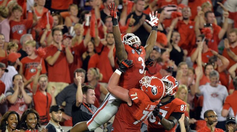 August 30, 2014 Athens, GA: Georgia Bulldogs running back Todd Gurley celebrates a 4th quarter touchdown against Clemson with teammate John Theus Saturday August 30, 2014 in Athens. BRANT SANDERLIN / BSANDERLIN@AJC.COM . Georgia running back Todd Gurley should be considered leading Heisman candidate. (Brant Sanderlin, AJC)