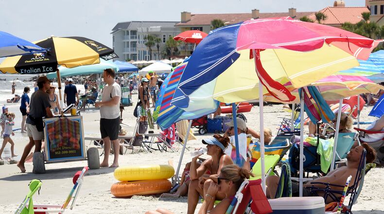Georgia's popular beach getaways, shown here last week, have become a major hotspot for the coronavirus disease, according to an Atlanta Journal-Constitution analysis of state health data. People continue to flock to beaches, many without masks. Ryon Horne/RHORNE@AJC.COM