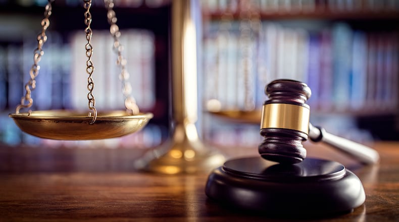 Judge gavel, scales of justice and law books in court