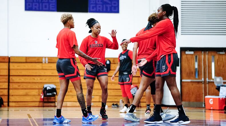 Atlanta Dream guard Odyssey Sims interacts with teammates during training camp.