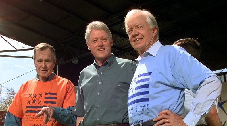 In this 1997 photo from a volunteer summit in Philadelphia, then President Bill Clinton is flanked by former Presidents George H.W. Bush( left) and Jimmy Carter (right, (AP Photo/Greg Gibson)