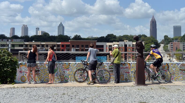 Runners, walkers and bikers stop and watch skyline on the Atlanta Beltline’s Eastside Trail in 2014.