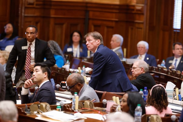 Georgia state representatives keep an eye on the voting board on Crossover Day. (Arvin Temkar/AJC)