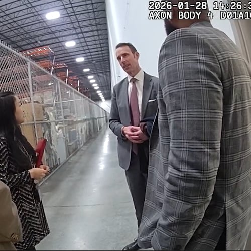 Body camera footage shows a conversation between Peter Ellis (right), the acting special agent in charge of the FBI's Atlanta field office, and Fulton County attorney Soo Jo during a raid of the county's election hub on Jan. 28, 2026. The FBI seized more than 650 boxes of 2020 ballots, which have long been a focus of discredited efforts to overturn the presidential election results. (Fulton County Police Department)